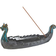 Decorative incense burner shaped like a dragon boat with two incense sticks on a white background