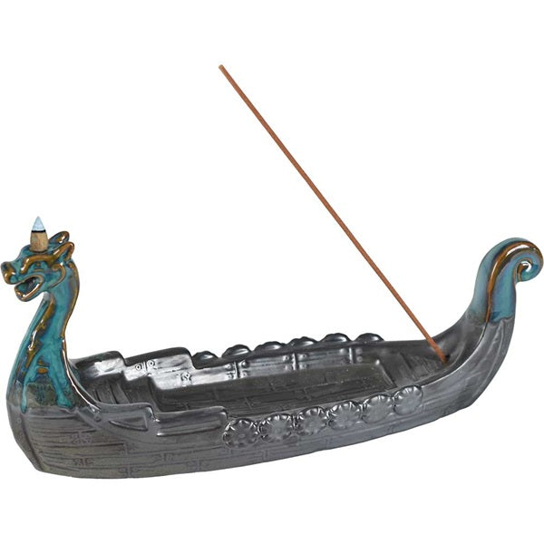 Decorative incense burner shaped like a dragon boat with two incense sticks on a white background
