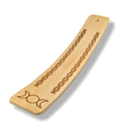 Wooden incense burner with engraved designs on a white background
