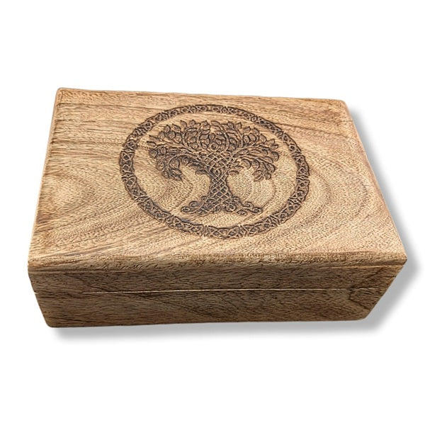 Wooden box with a tree of life engraving on a white background
