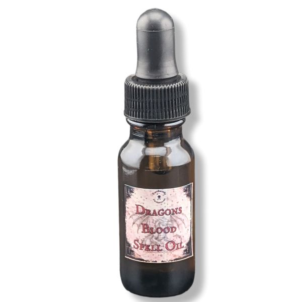 A small amber glass dropper bottle with a black rubber-and-plastic dropper cap and a vintage-style label reading 'Dragons Blood Spell Oil' on a white background.