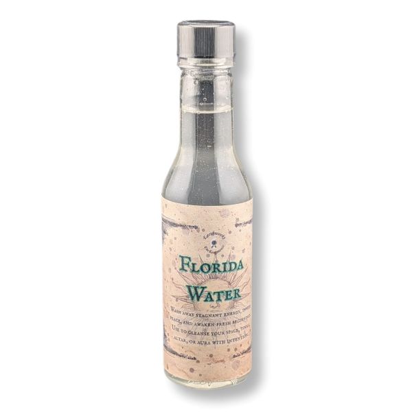 A bottle of Earthworks Enchantments Florida Water on a white background.