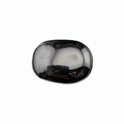 Black tourmaline palm stone with a reflective surface on a white background