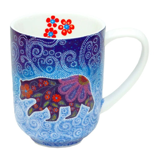 Mug with a colorful bear design on a blue patterned background