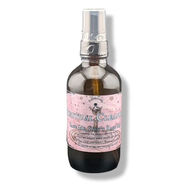 A dark amber glass spray bottle with a  label reading 'Spiritual Cleansing'  on a white background.