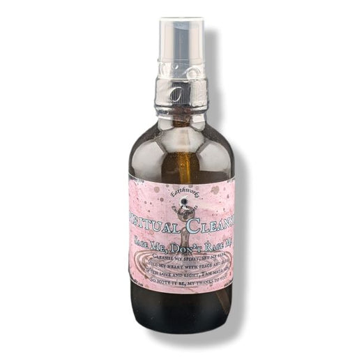 A dark amber glass spray bottle with a  label reading 'Spiritual Cleansing'  on a white background.