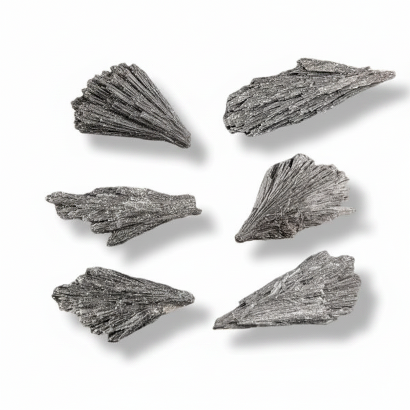 Black kyanite with fluted surface arranged in a grid on a white background with soft drop shadows.