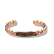Copper bracelet with engraved designs on a white background