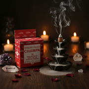 Dragon's Blood Champa incense with packaging and candles on a dark background