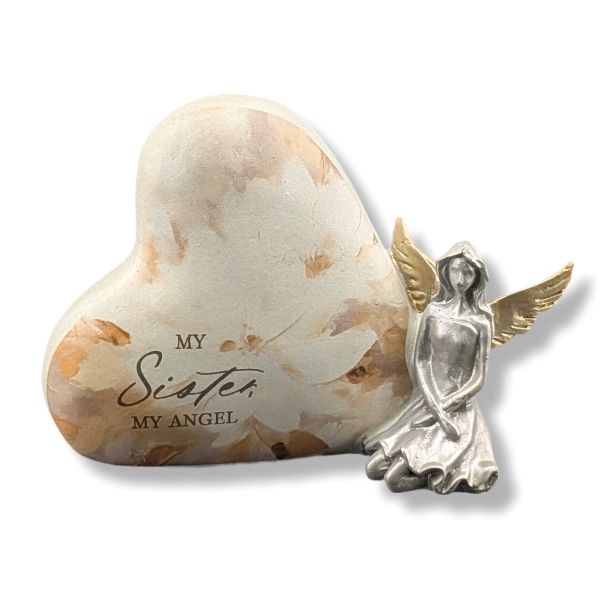 Heart-shaped stone with 'My Sister, My Angel' text and a silver angel figurine on a white background