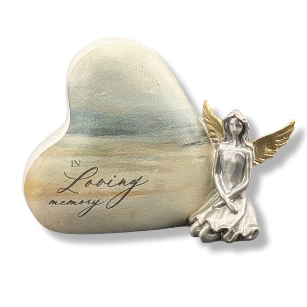 Heart-shaped stone with 'In Loving Memory' engraving and an angel figurine on a white background