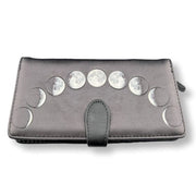 Black wallet with silver moon phase embellishments on a white background