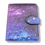 Purple and blue wallet with star and constellation design on a white background
