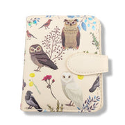 Small zipper wallet with owl and bird design on a beige background
