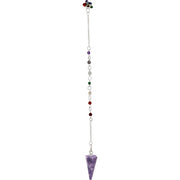 Purple crystal pendulum on a white background