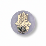 A selenite charge plate with a golden Hand Of Fatima, shown on a clean white studio background.