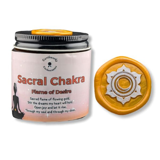 Sacral Chakra candle with packaging and decorative disc on a white background