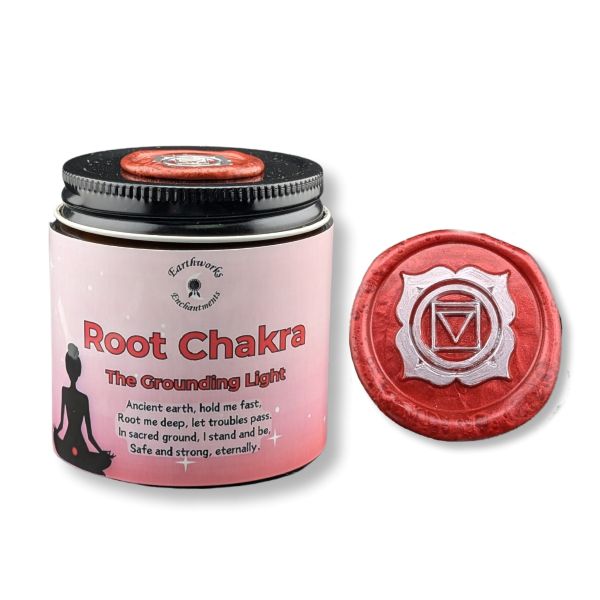 Pink candle labeled 'Root Chakra' with a red lid featuring a chakra symbol on a white background.
