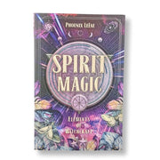 The book cover of 'Spirit Magic: Elements of Witchcraft' by Phoenix LeFae, featuring a mystical purple and blue design with a central circular emblem, stars, and illustrations of butterflies and flowers.