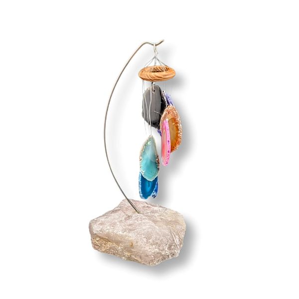 Decorative wind chime with colorful stones on a white background