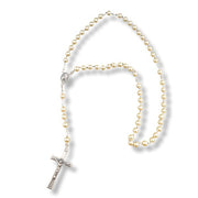 Rosary with gold beads and a silver cross on a white background