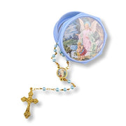 Rosary with gold cross and pearl beads in a decorative case on a white background