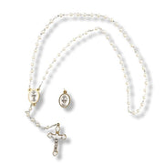 Pearl necklace with gold accents on a white background
