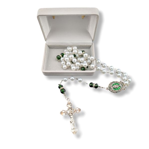 Pearl and green stone rosary with a silver cross in an open gray jewelry box on a white background.