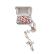 Pink rosary with a silver cross on a white background