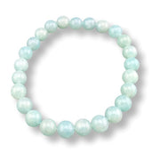 Beaded bracelet with light green beads on a white background