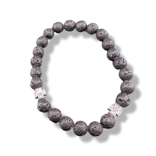 Lava stone bracelet with silver charms on a white background