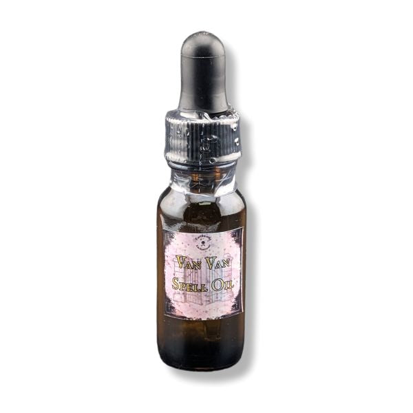 A small amber glass dropper bottle with a black rubber bulb top. The bottle has a vintage-style label that reads 'Van Van Spell Oil' with a pink background and illustration of a shell.