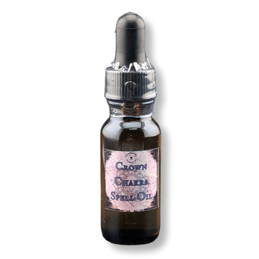 A small amber glass dropper bottle labeled 'Crown Chakra Spell Oil' with a black rubber dropper cap and a pinkish label, shown on a white background.