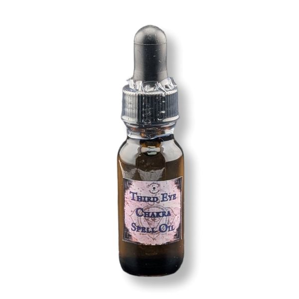 A small amber glass dropper bottle labeled 'Third Eye Chakra Spell Oil' on a white background.