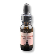Bottle of 'Sacral Chakra' oil with a pink label on a white background