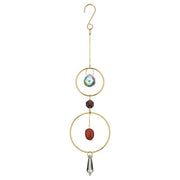 Decorative hanging ornament with gold loops, beads, and crystal on a white background