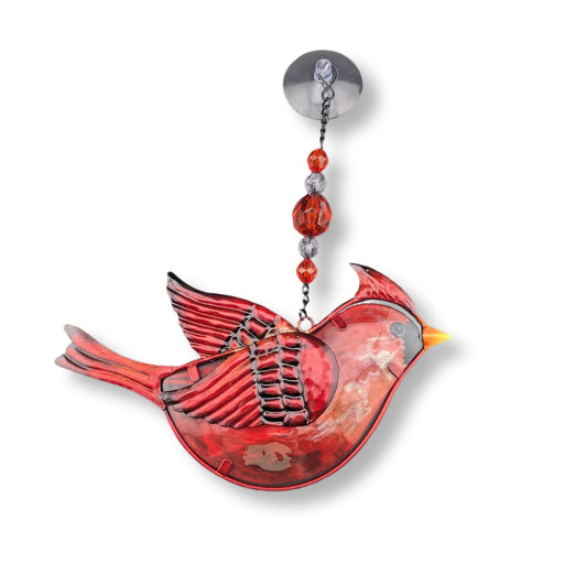 Decorative red bird ornament with beads on a white background