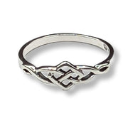 Silver ring with intricate design on a white background