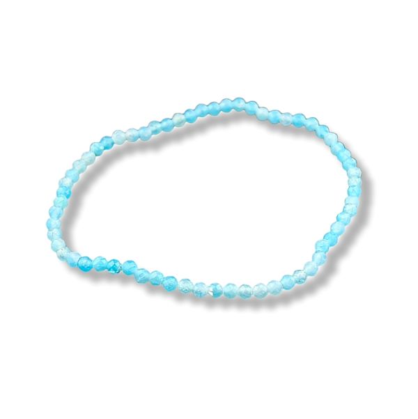 A beaded stretch bracelet made of light blue and white faceted beads, arranged in an oval shape on a white background with a soft drop shadow.