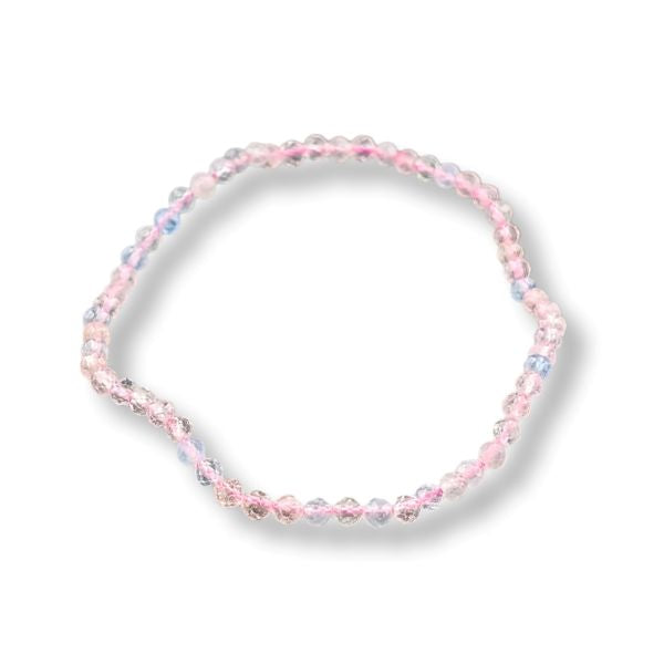A beaded stretch bracelet featuring alternating strands of light pink and pastel blue faceted beads, displayed on a clean white background with a soft drop shadow.