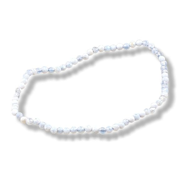A beaded stretch necklace made of small, round white beads with subtle light blue marbling, displayed on a clean white background with a soft drop shadow.