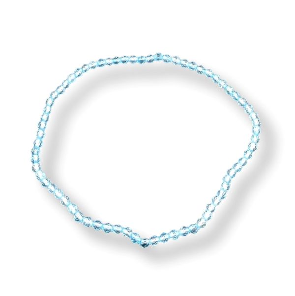 A delicate light blue beaded bracelet arranged in a loose circle on a white background with a soft drop shadow.