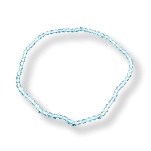 A delicate light blue beaded bracelet arranged in a loose circle on a white background with a soft drop shadow.