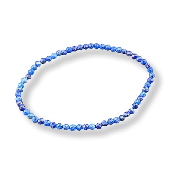 A beaded stretch bracelet made of small faceted blue beads, arranged in a circular shape on a white background with a soft drop shadow.