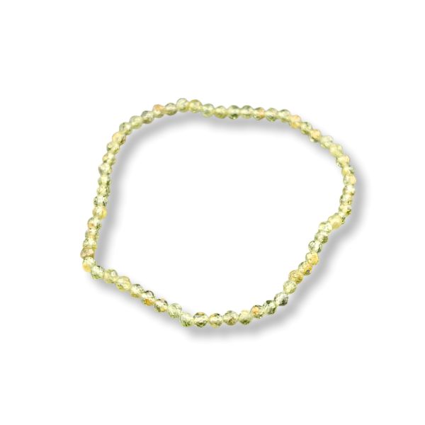 A single beaded stretch bracelet made of small faceted beads in a pale yellow-green color, shown on a plain white background with a soft drop shadow.