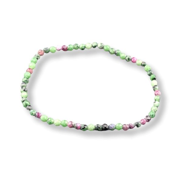 A beaded stretch bracelet made of small round gemstone beads in shades of green, pink, and black, arranged in an oval shape on a white background.