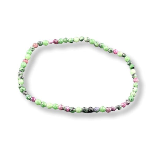 A beaded stretch bracelet made of small round gemstone beads in shades of green, pink, and black, arranged in an oval shape on a white background.