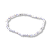 A beaded stretch bracelet made of small round tanzanite beads  light blue, and pale lavender, shown on a white background with a soft drop shadow.