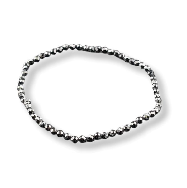 A single beaded bracelet made of small faceted dark metallic beads, arranged in an oval shape on a clean white background.
