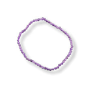 A single beaded bracelet made of small faceted purple beads, arranged in a loose circle on a clean white background.